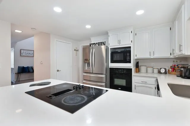 a kitchen with a refrigerator stove and sink
