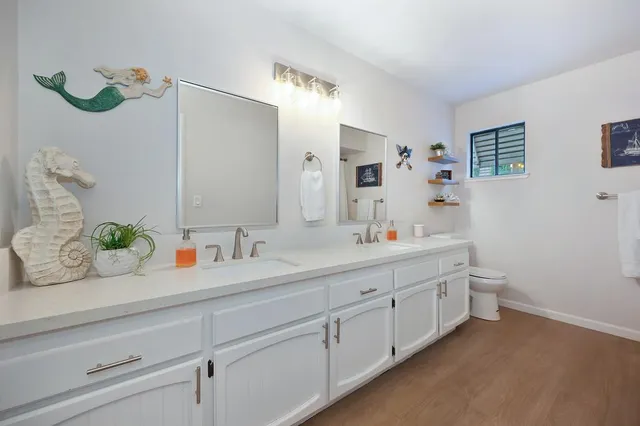 a bathroom with a double vanity sink and a mirror