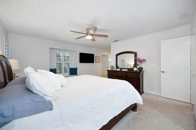 a bedroom with a large bed and a chandelier