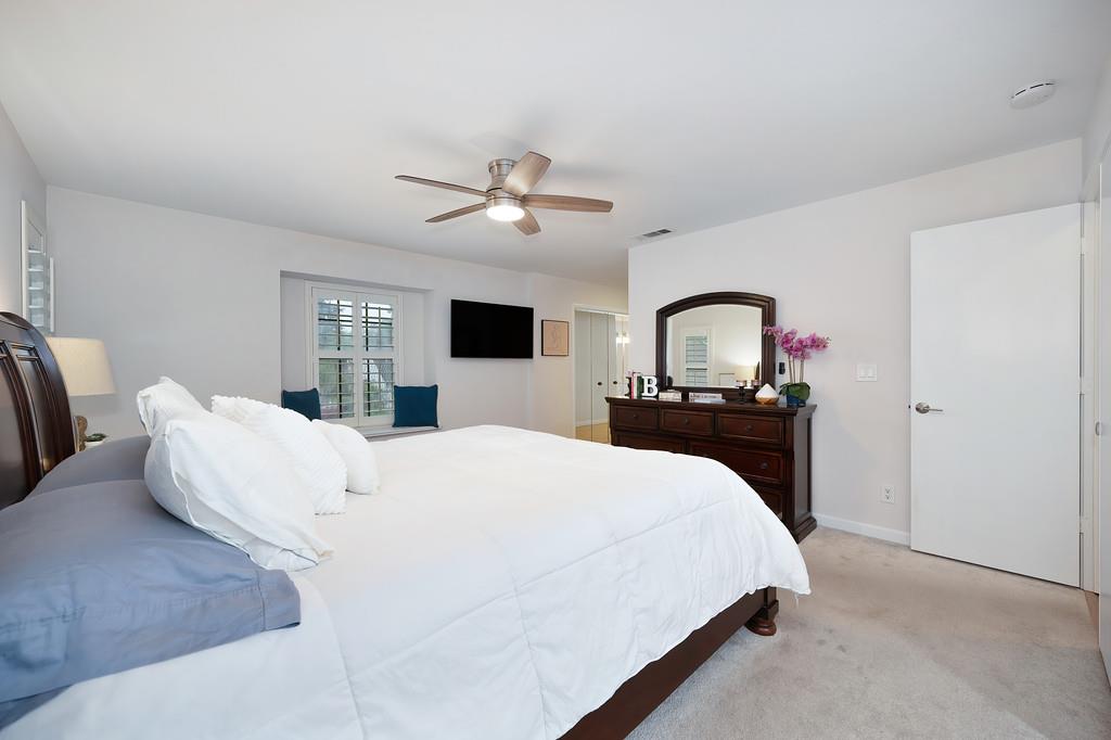 8477 Rick Mary Court Fair Oaks, CA 95628 - Photo 33 of 48 a bedroom with a large bed and a chandelier