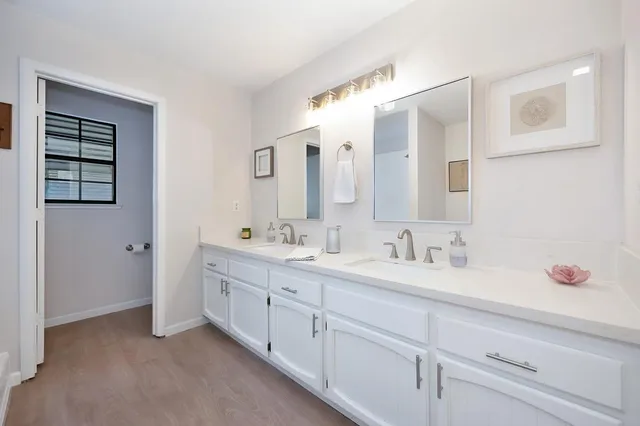 a bathroom with a double vanity sink and mirror