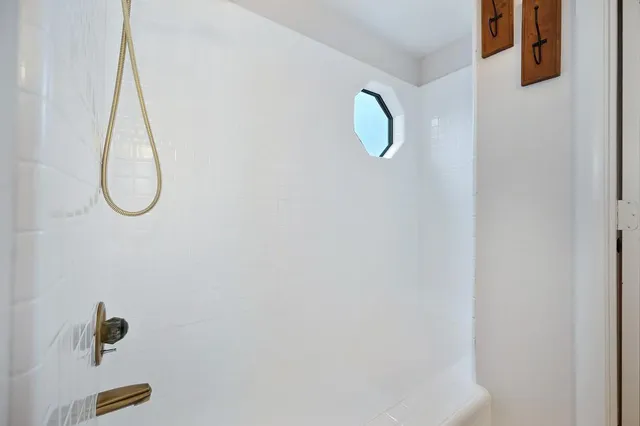 a bathroom with a shower and mirror