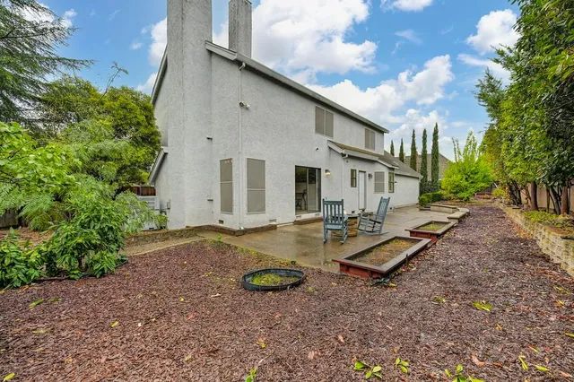 a view of a backyard with plants and a patio