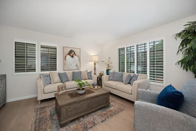 a living room with furniture and a large window