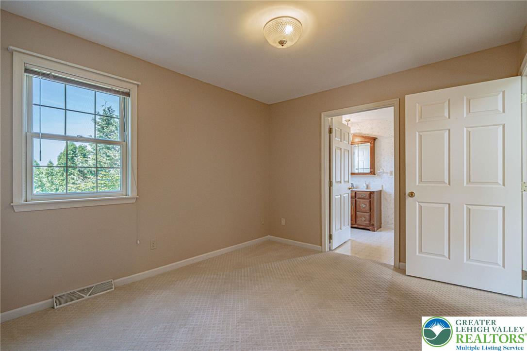 4542 Springfield Drive Coplay, PA 18037 - Photo 26 of 89 A well-lit bedroom features plush carpeting and a sunny window.