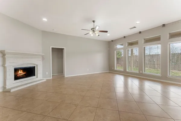 a view of an empty room with a fireplace and a window