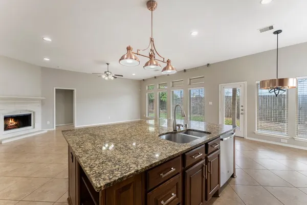 a kitchen with granite countertop a stove and a sink