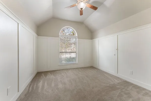 a bathroom with a granite countertop sink a toilet and a mirror