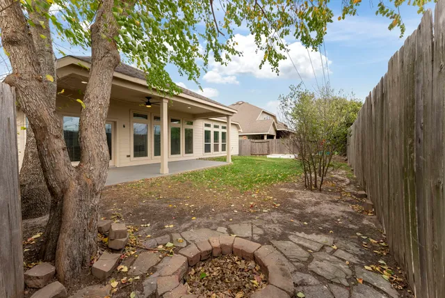 an aerial view of a residential houses with outdoor space and lake view