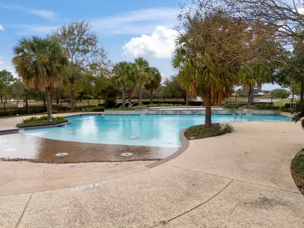 an aerial view of a residential houses with outdoor space and lake view