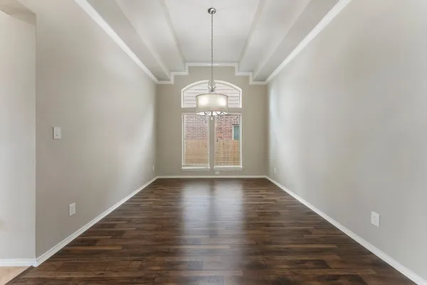 a view of a room with wooden floor