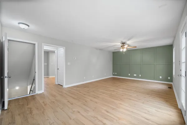 a view of empty room with wooden floor