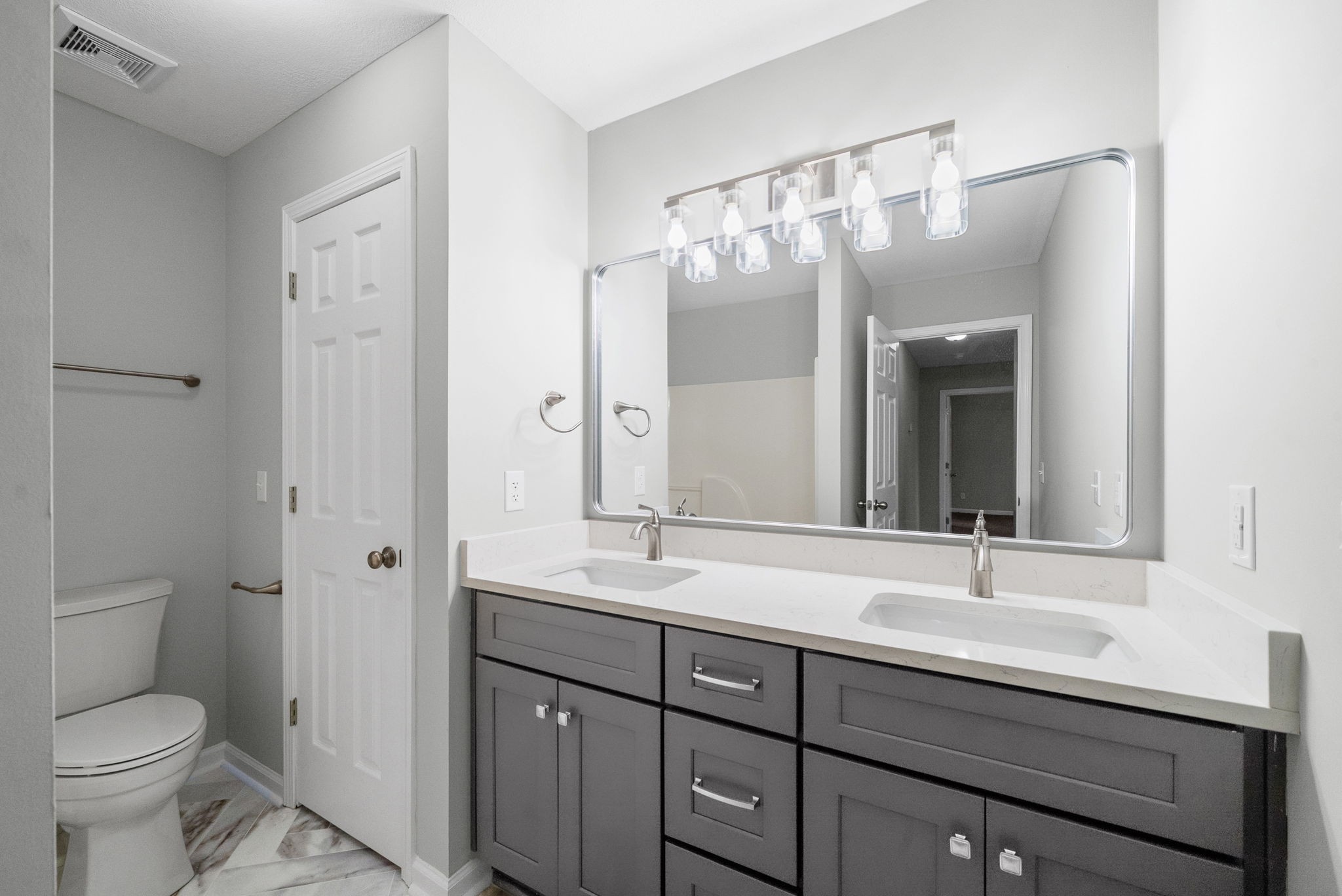 3118 Larson Lane Clarksville, TN 37043 - Photo 27 of 37 a bathroom with a double vanity sink toilet and mirror