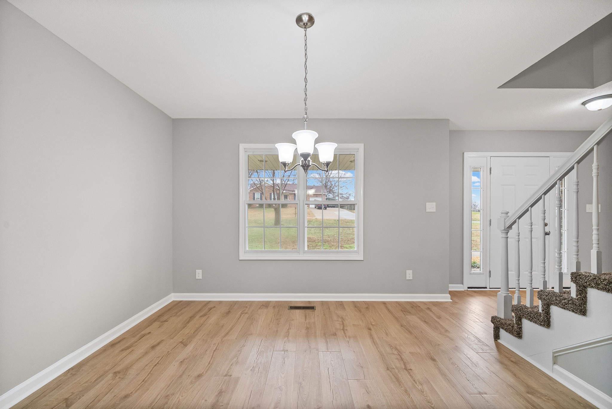 3118 Larson Lane Clarksville, TN 37043 - Photo 9 of 37 a view of a room with window wooden floor and chandelier