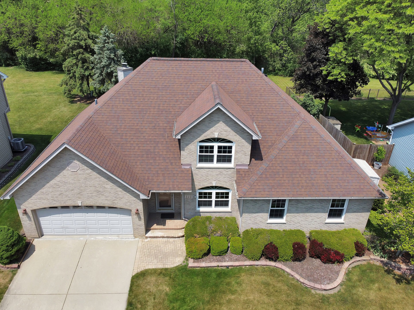 a aerial view of a house next to a yard