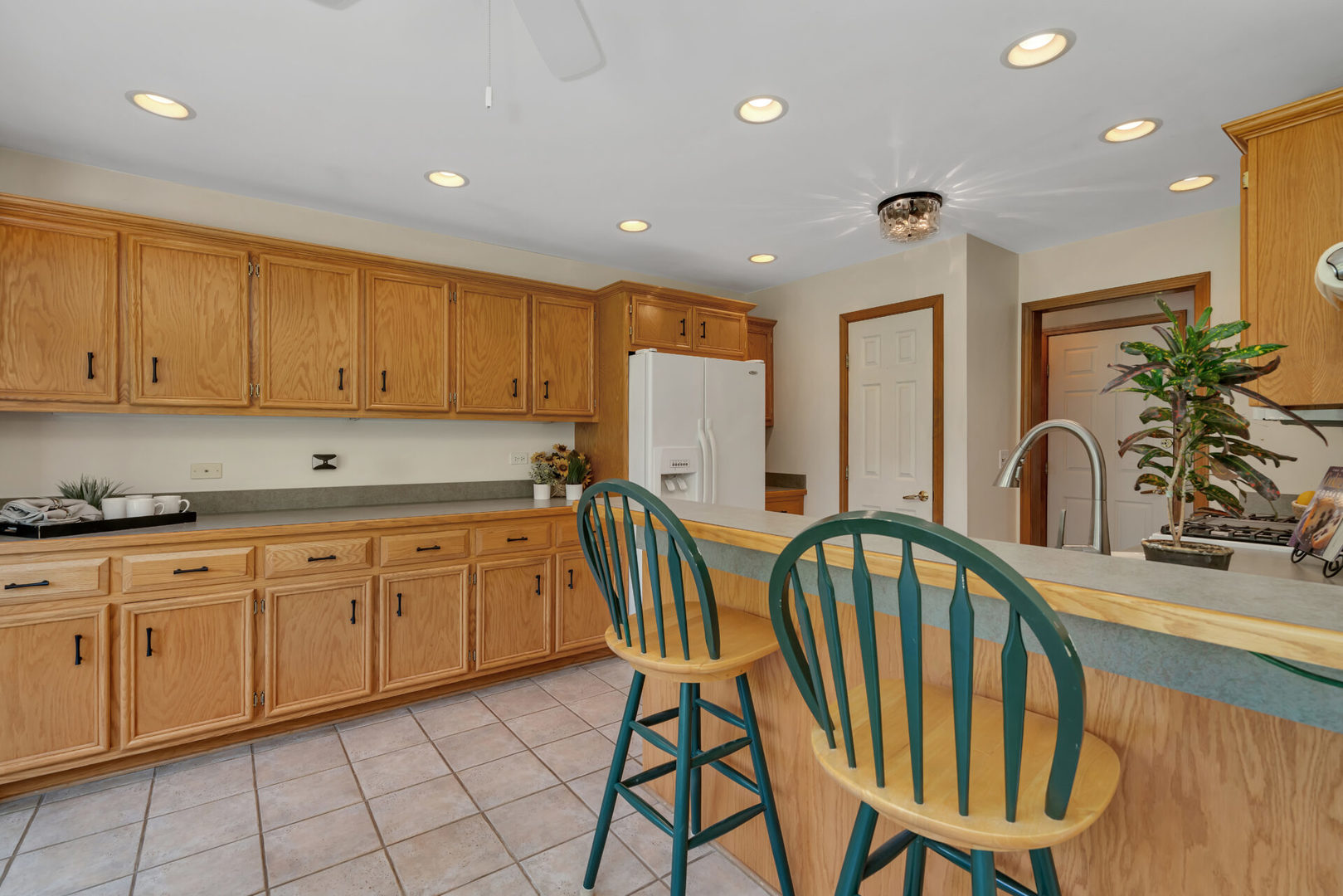 515 Boardman Circle Bolingbrook, IL 60440 - Photo 10 of 31 a open kitchen with stainless steel appliances granite countertop a sink a stove a dining table and chairs