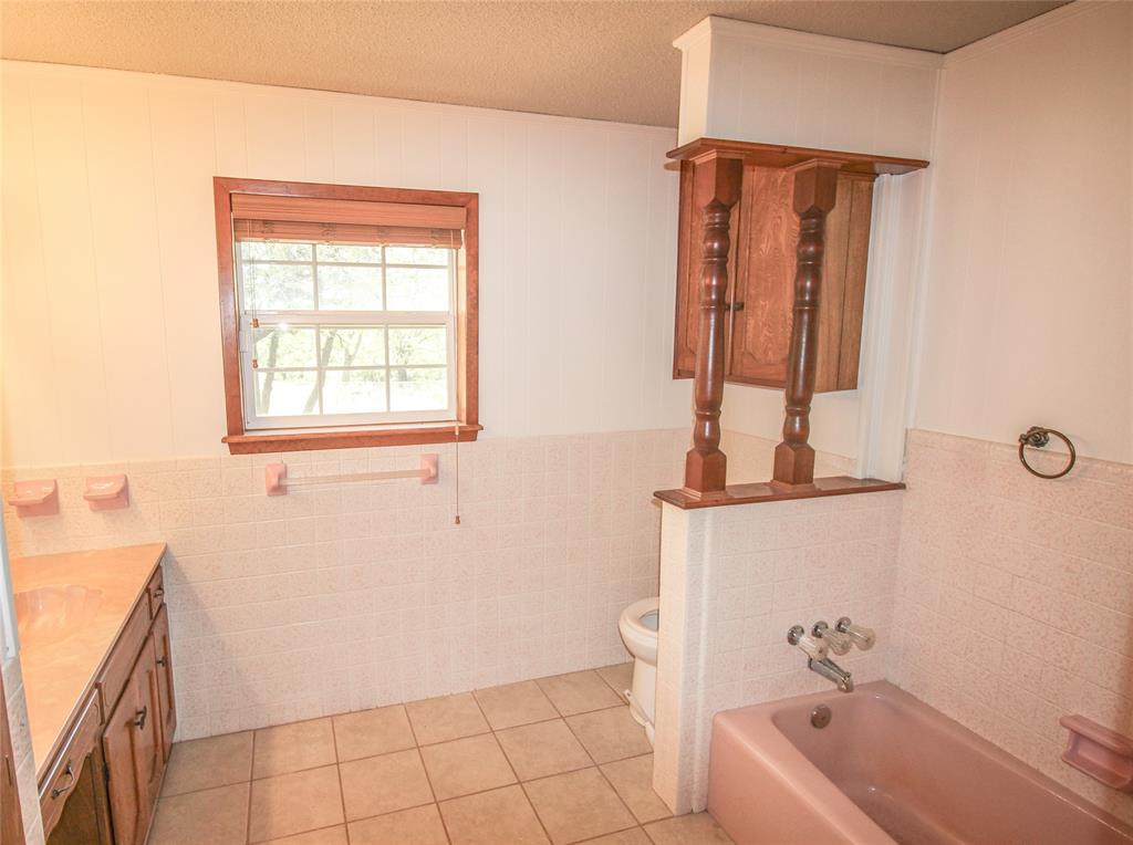 Tbd Crooked Creek Road Bowie, TX 76230 - Photo 14 of 35 a bathroom with a tub sink and mirror