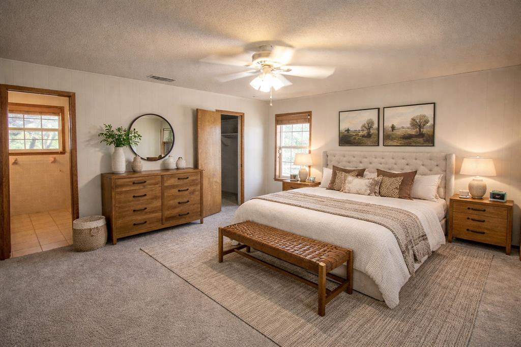 Tbd Crooked Creek Road Bowie, TX 76230 - Photo 17 of 35 a bedroom with a bed and a chandelier