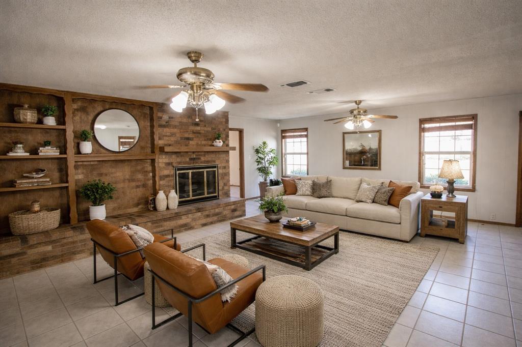 Tbd Crooked Creek Road Bowie, TX 76230 - Photo 19 of 35 a living room with furniture a fireplace and a large window