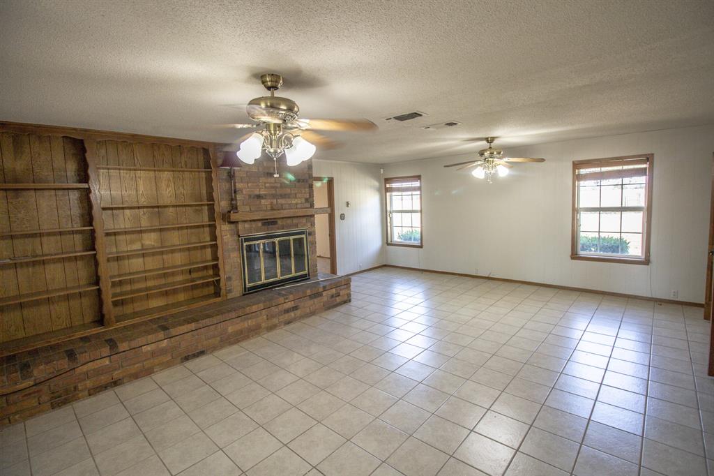 Tbd Crooked Creek Road Bowie, TX 76230 - Photo 20 of 35 a view of a livingroom with a chandelier fan and windows