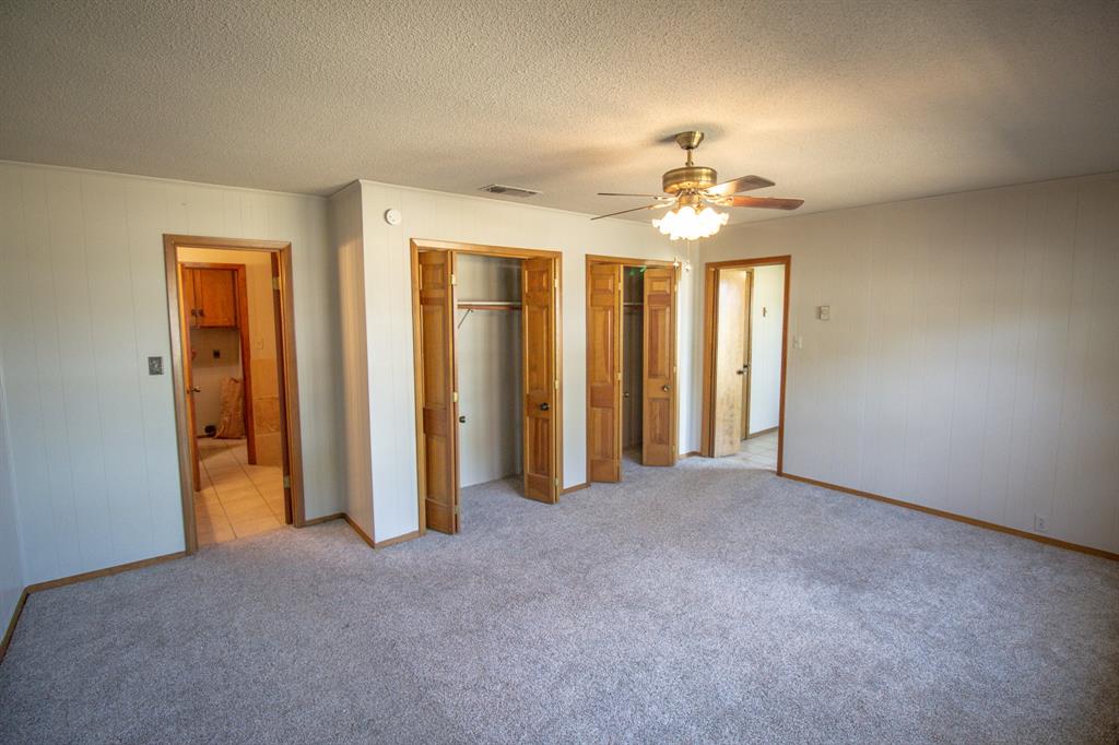 Tbd Crooked Creek Road Bowie, TX 76230 - Photo 22 of 35 an empty room with windows and fan chandelier