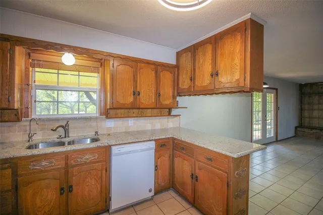 a kitchen with stainless steel appliances granite countertop a sink and a cabinets