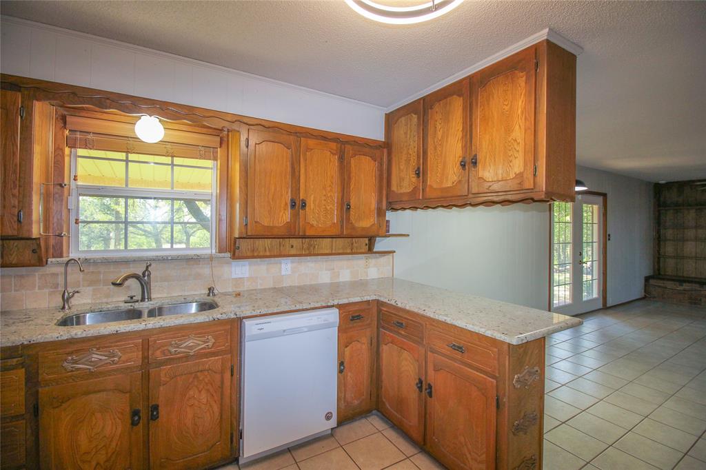 Tbd Crooked Creek Road Bowie, TX 76230 - Photo 10 of 35 a kitchen with stainless steel appliances granite countertop a sink and a cabinets