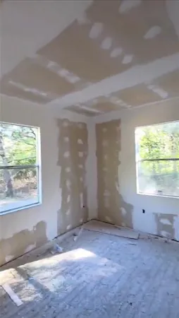 a view of a livingroom with wooden floor and a window