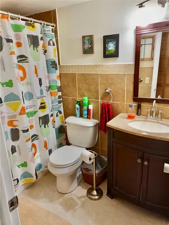 a bathroom with a sink toilet and a mirror