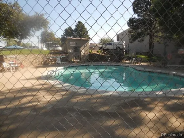 a view of a small yard and a wooden fence