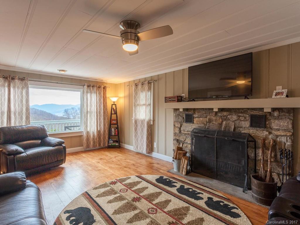 1267 Walker Road Waynesville, NC 28786 - Photo 3 of 23 a living room with furniture and a flat screen tv