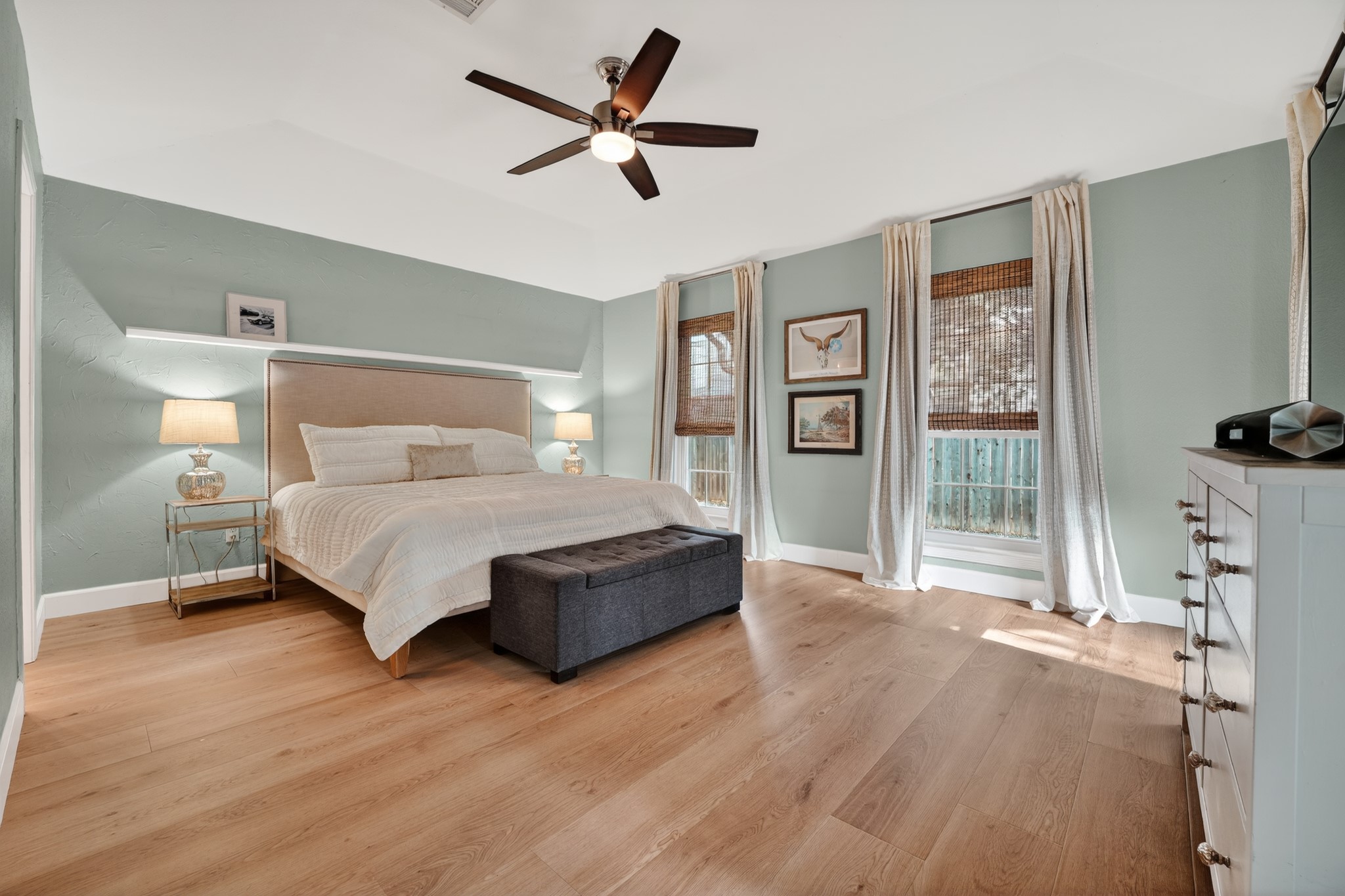1811 Old Mill Road Cedar Park, TX 78613 - Photo 20 of 39 Well-lit sleeping quarters with rich hardwood flooring and a stylish ceiling fan.
