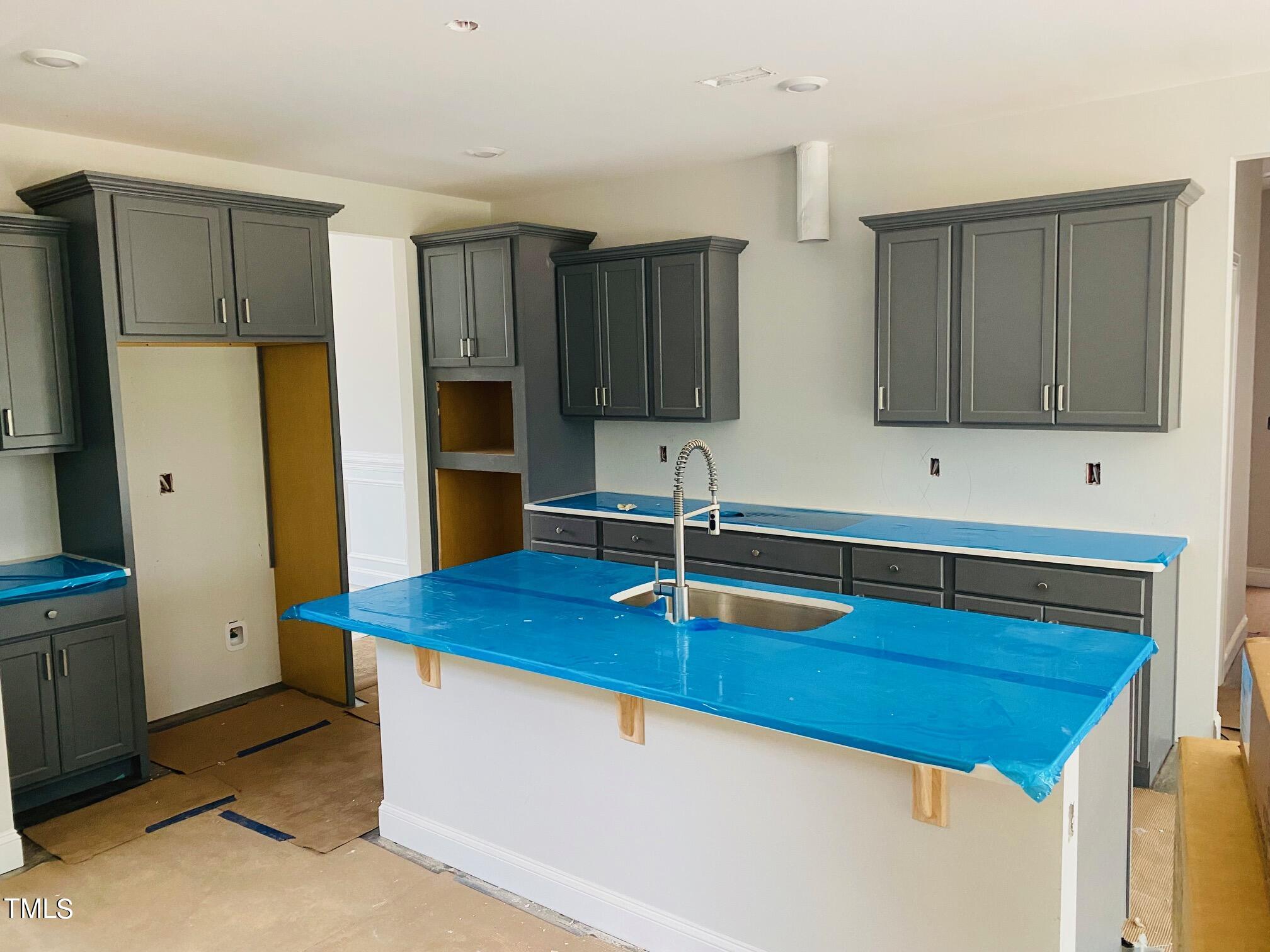 817 Putney Hl Road Zebulon, NC 27597 - Photo 2 of 6 a kitchen with stainless steel appliances granite countertop a sink refrigerator and cabinets