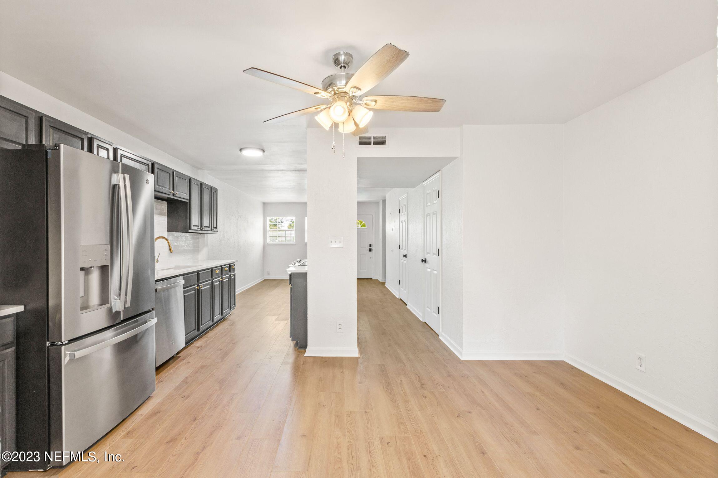 818 Cavalla Road Atlantic Beach, FL 32233 - Photo 15 of 27 a kitchen with stainless steel appliances a refrigerator and wooden floor