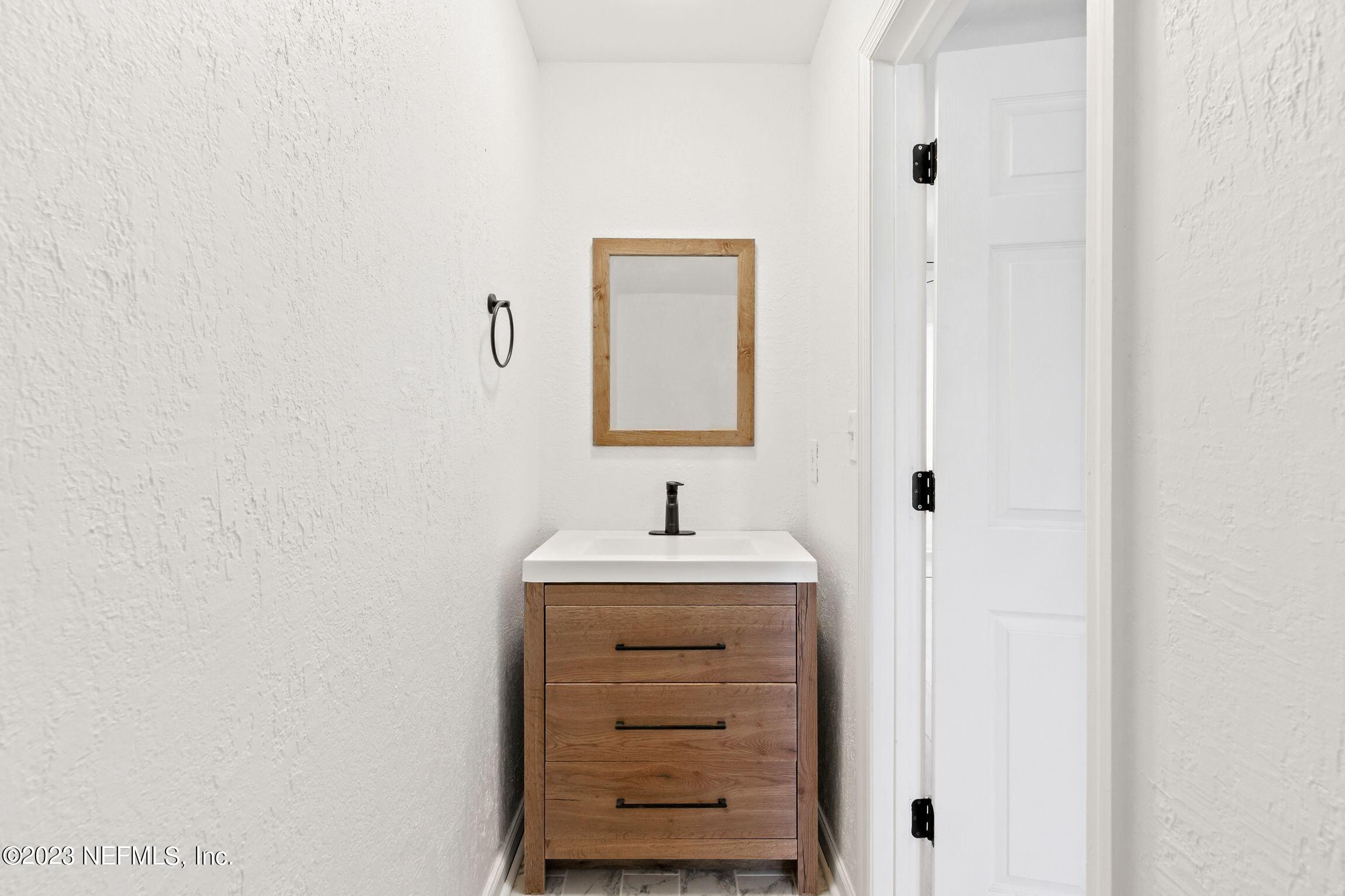 818 Cavalla Road Atlantic Beach, FL 32233 - Photo 16 of 27 a bathroom with a sink and a mirror