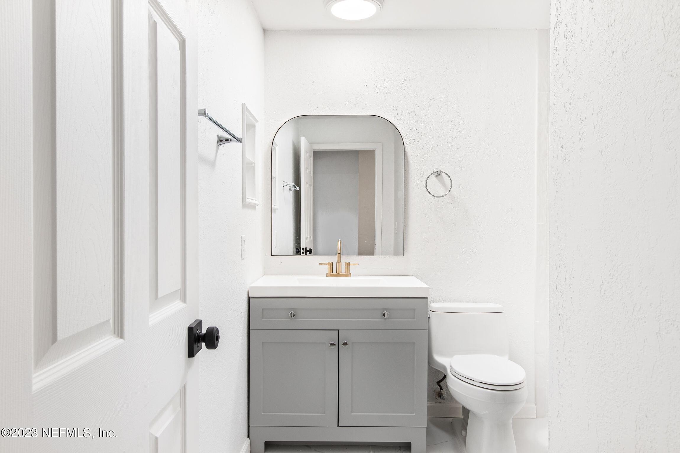 818 Cavalla Road Atlantic Beach, FL 32233 - Photo 19 of 27 a bathroom with a sink a toilet and a mirror