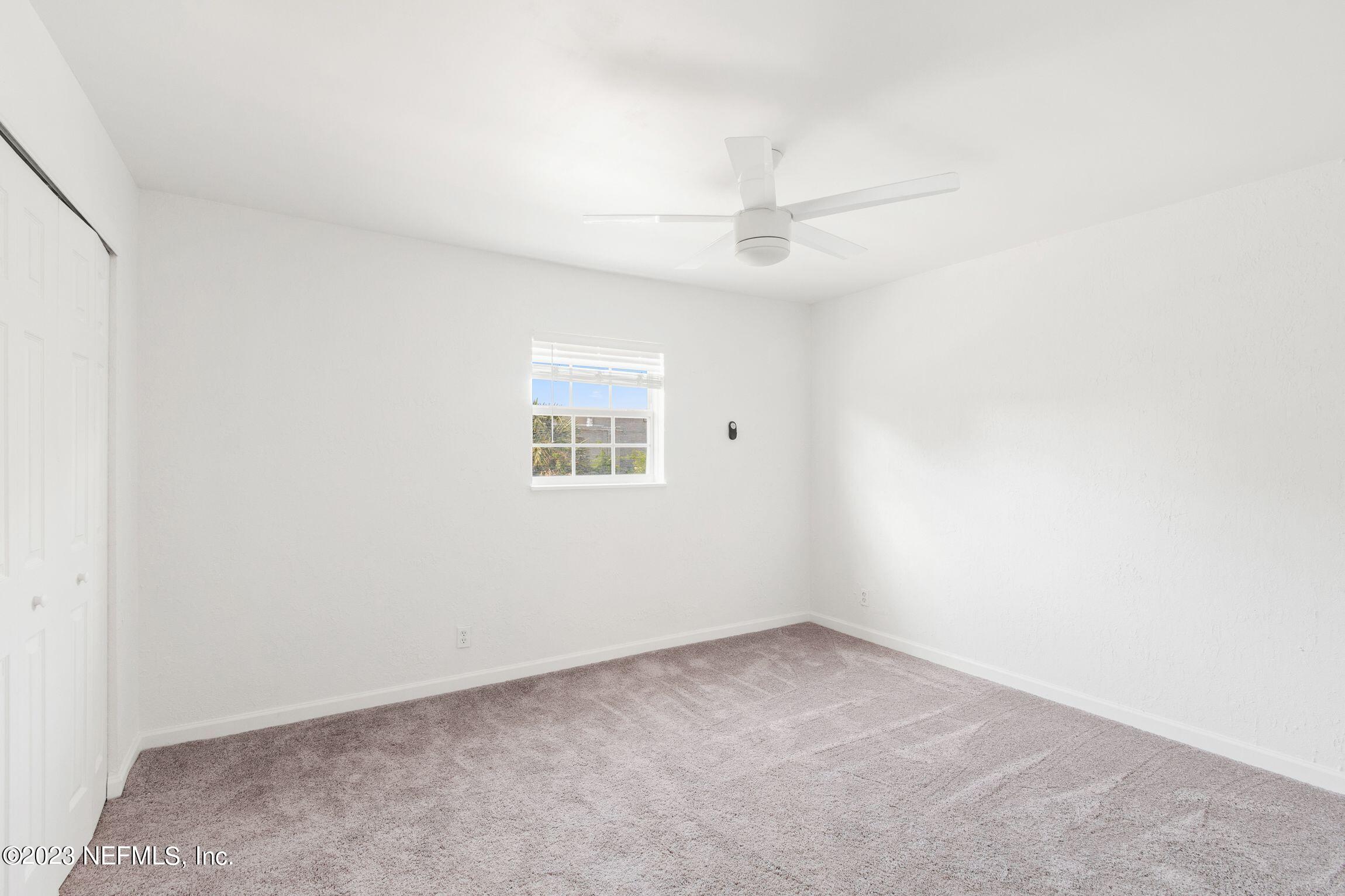 818 Cavalla Road Atlantic Beach, FL 32233 - Photo 21 of 27 an empty room with a window and ceiling fan