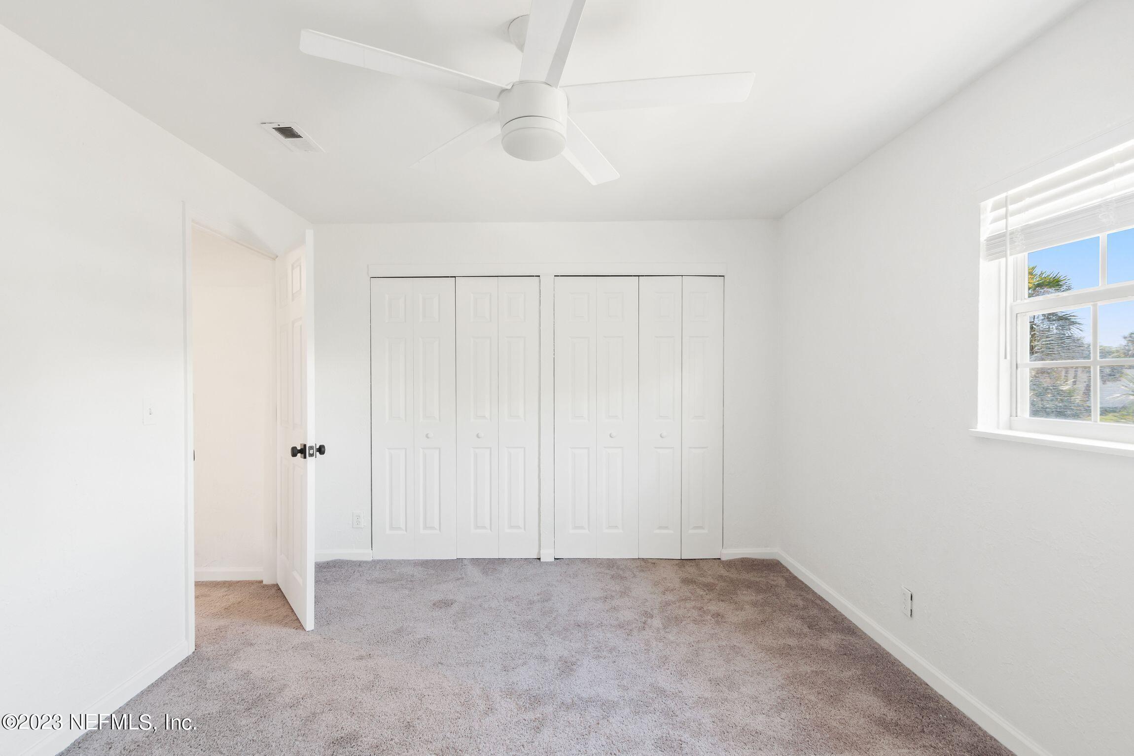 818 Cavalla Road Atlantic Beach, FL 32233 - Photo 22 of 27 an empty room with windows and closet