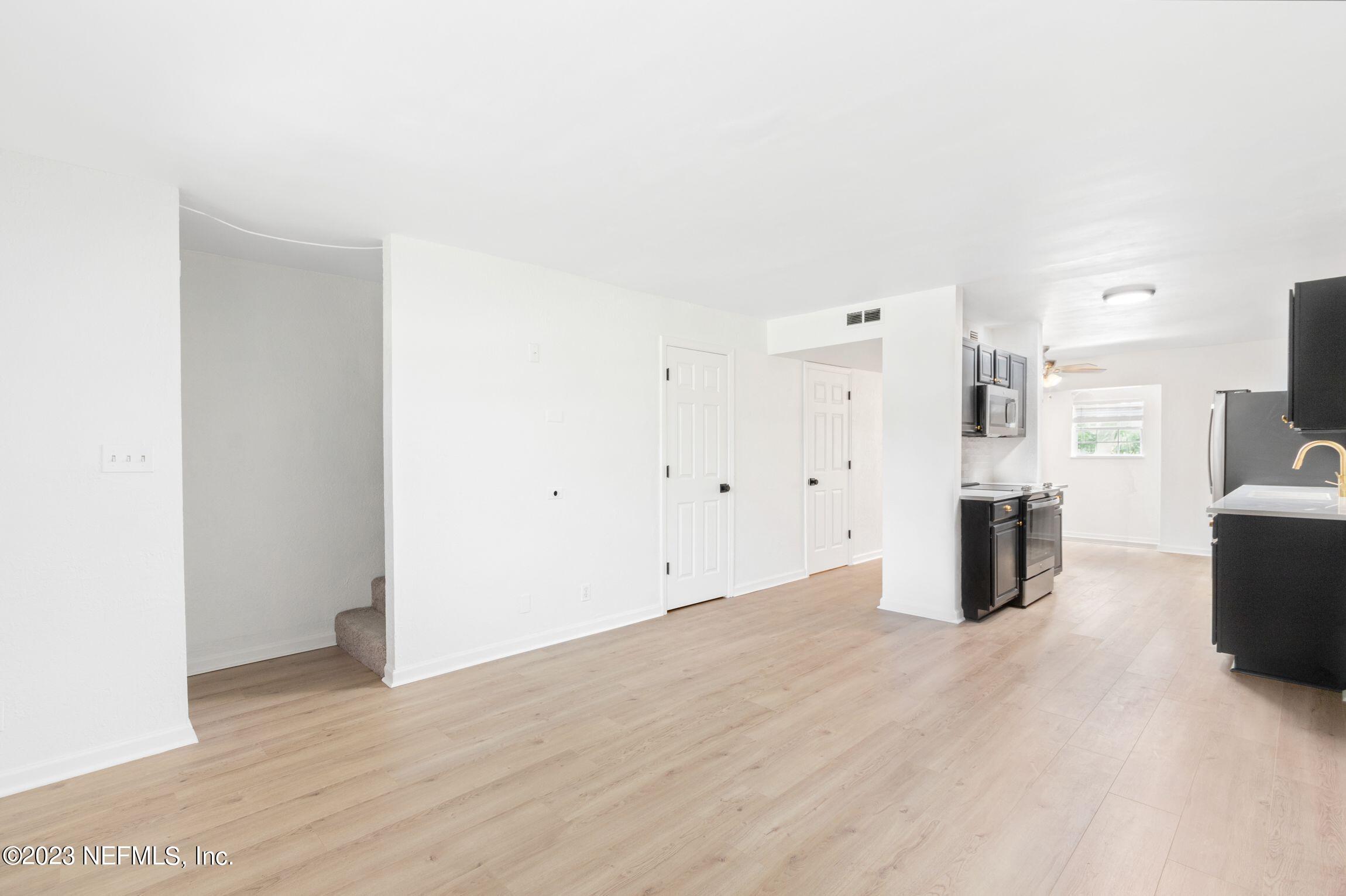 818 Cavalla Road Atlantic Beach, FL 32233 - Photo 5 of 27 a view of kitchen with refrigerator and wooden floor