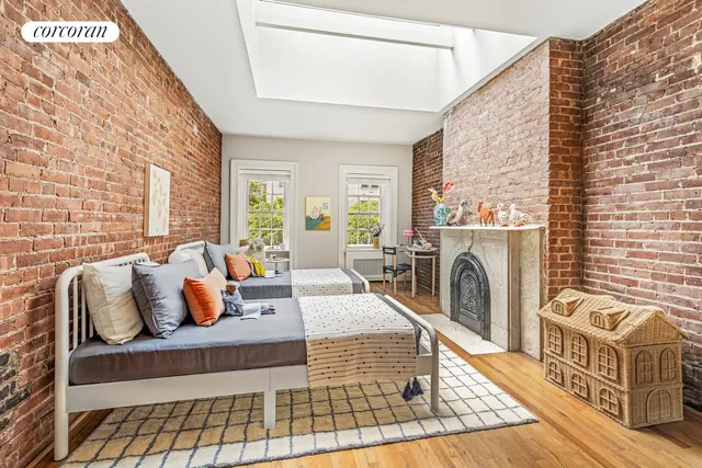 a living room with furniture a fireplace and a large window