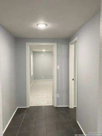 a view of a room with an empty space and a window