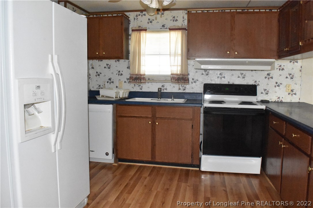 4131 Carroll Store Road Autryville, NC 28318 - Photo 8 of 18 a kitchen with granite countertop a sink cabinets and stainless steel appliances