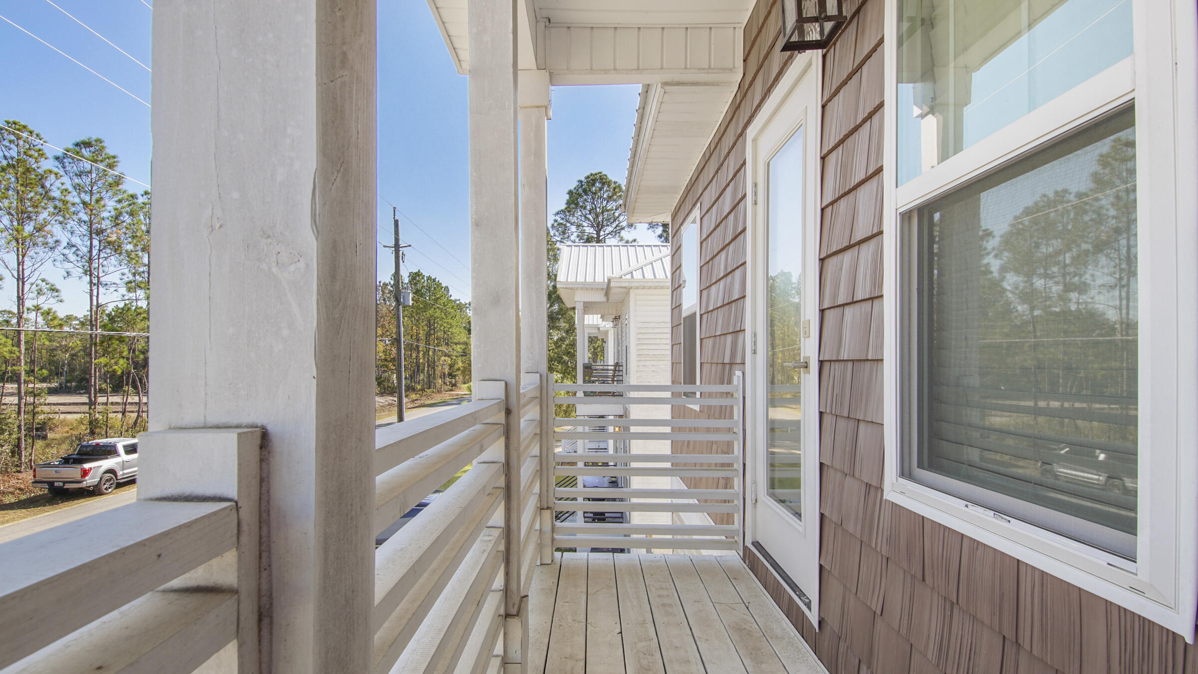 275 Indian Woman Road Santa Rosa Beach, FL 32459 - Photo 14 of 43 a view of a balcony with wooden floor