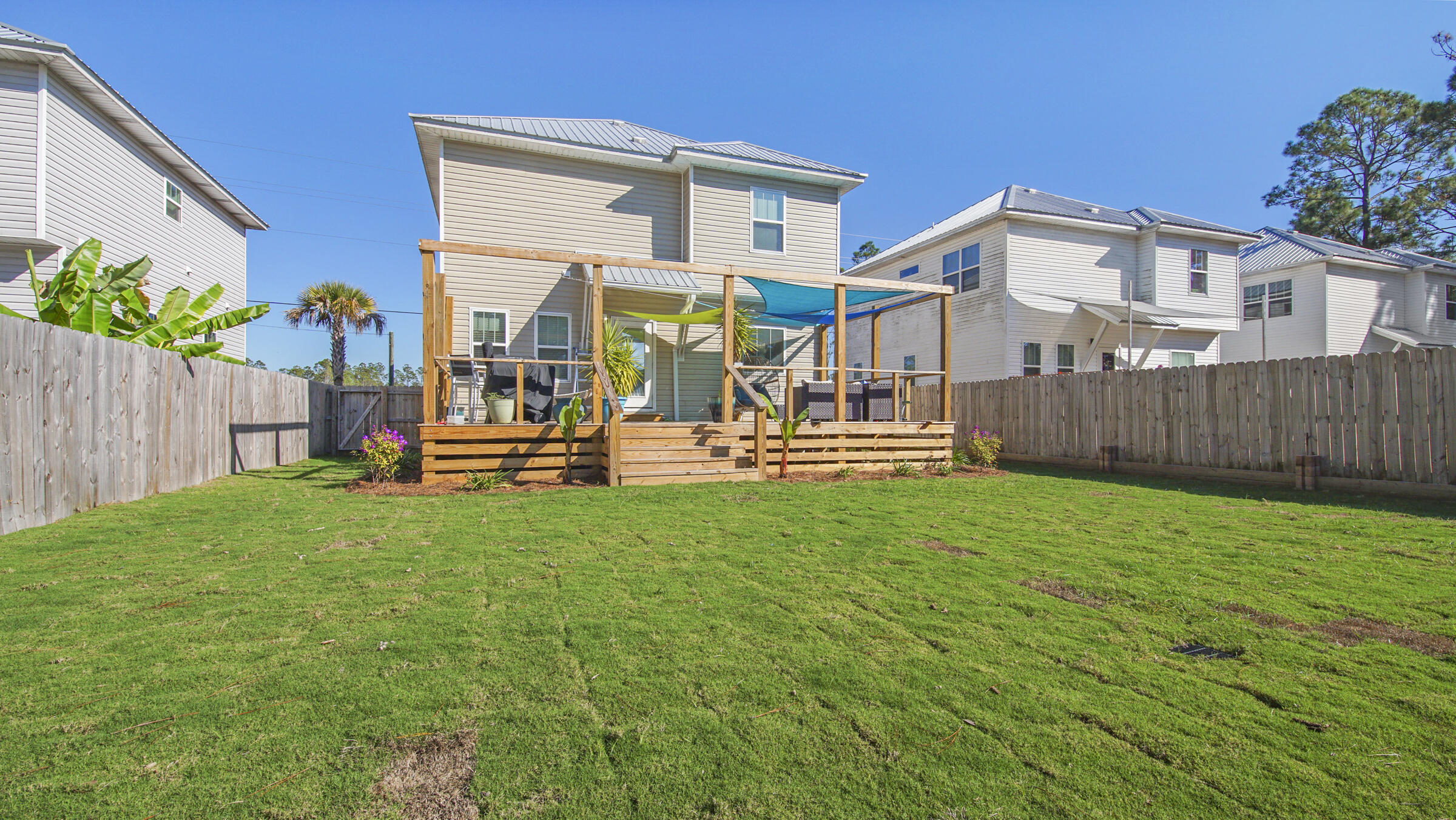 275 Indian Woman Road Santa Rosa Beach, FL 32459 - Photo 18 of 43 a view of a house with backyard and sitting area