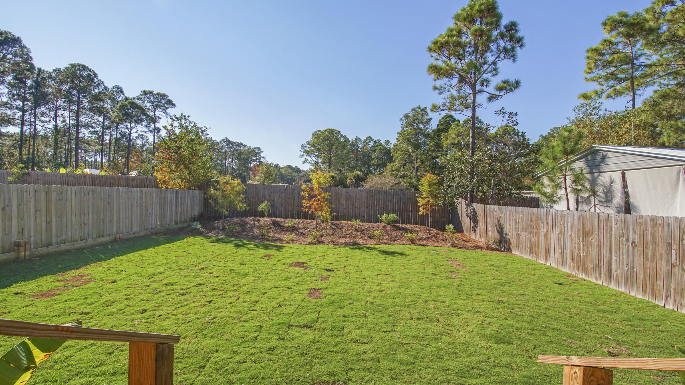 275 Indian Woman Road Santa Rosa Beach, FL 32459 - Photo 19 of 43 a view of a backyard with a garden