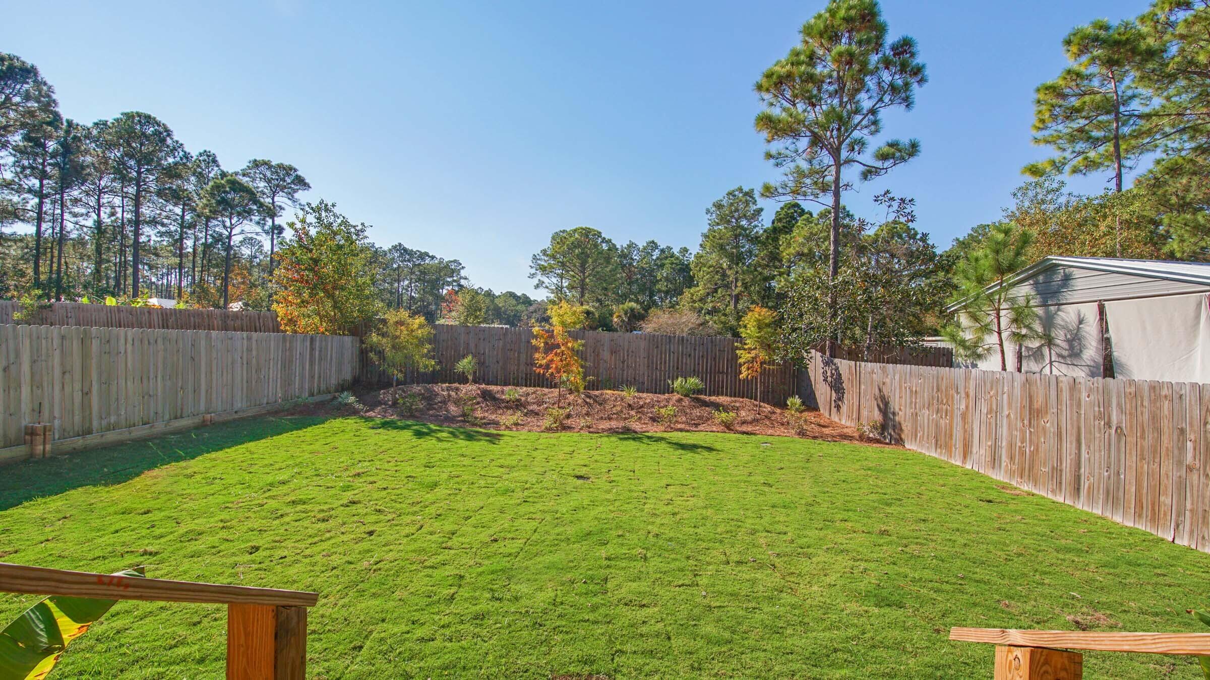 275 Indian Woman Road Santa Rosa Beach, FL 32459 - Photo 28 of 43 a view of a backyard with a garden