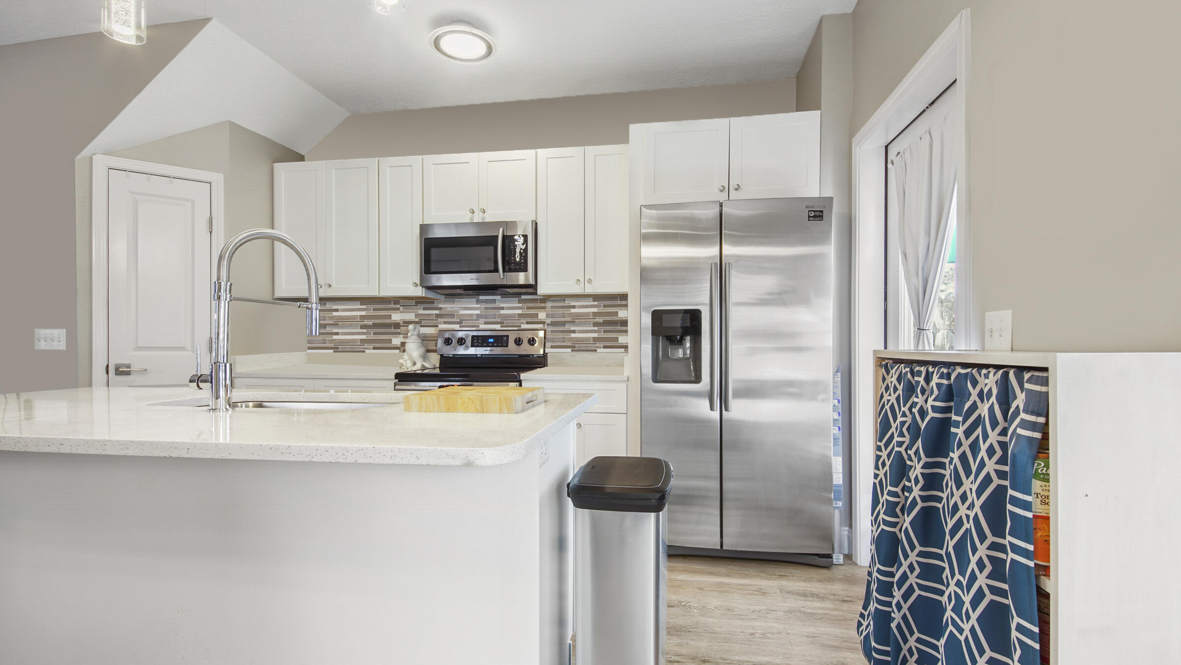 275 Indian Woman Road Santa Rosa Beach, FL 32459 - Photo 38 of 43 a kitchen with stainless steel appliances granite countertop a refrigerator a stove and a sink with wooden floor