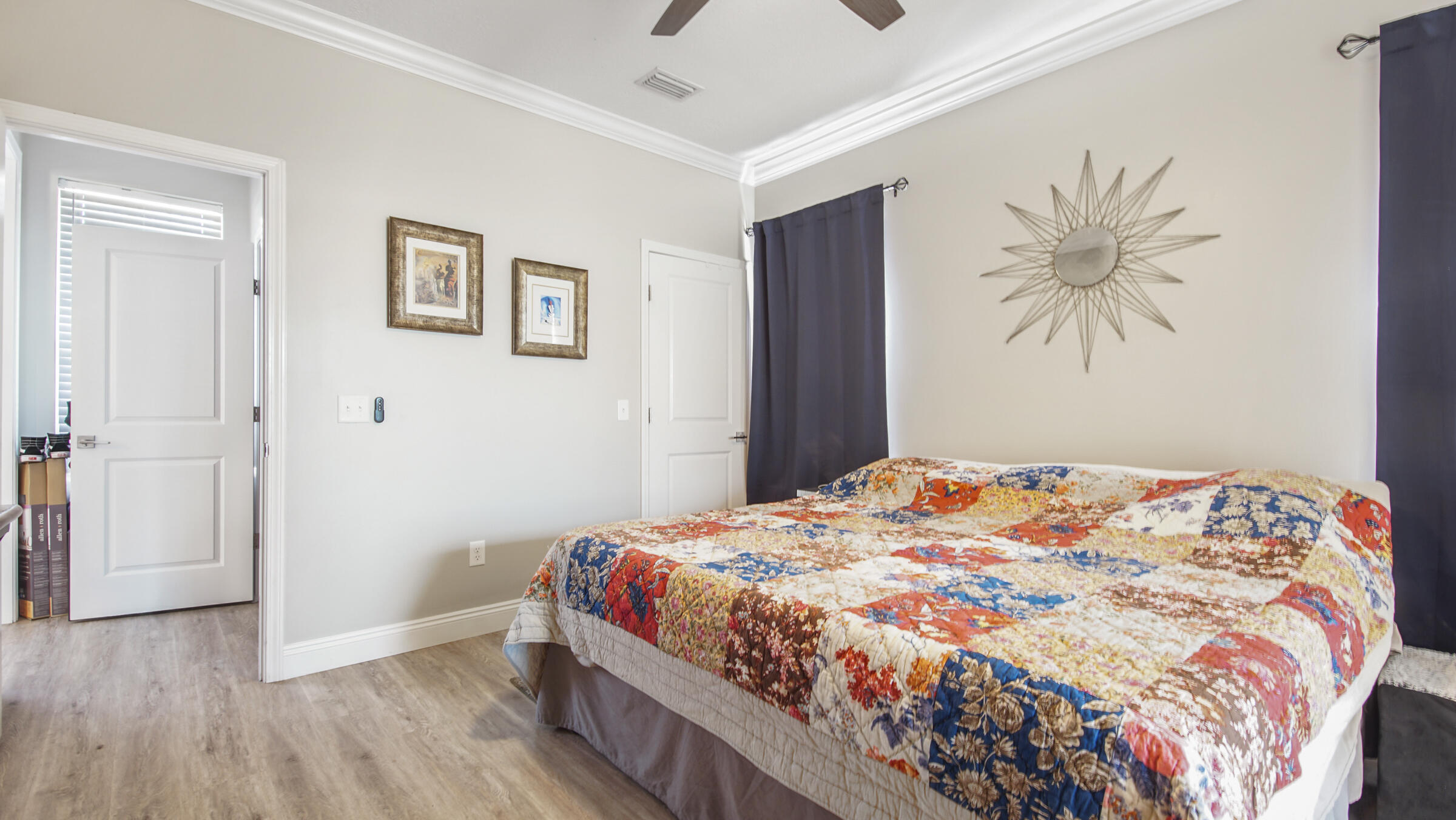 275 Indian Woman Road Santa Rosa Beach, FL 32459 - Photo 8 of 43 a bedroom with a large bed and a chandelier