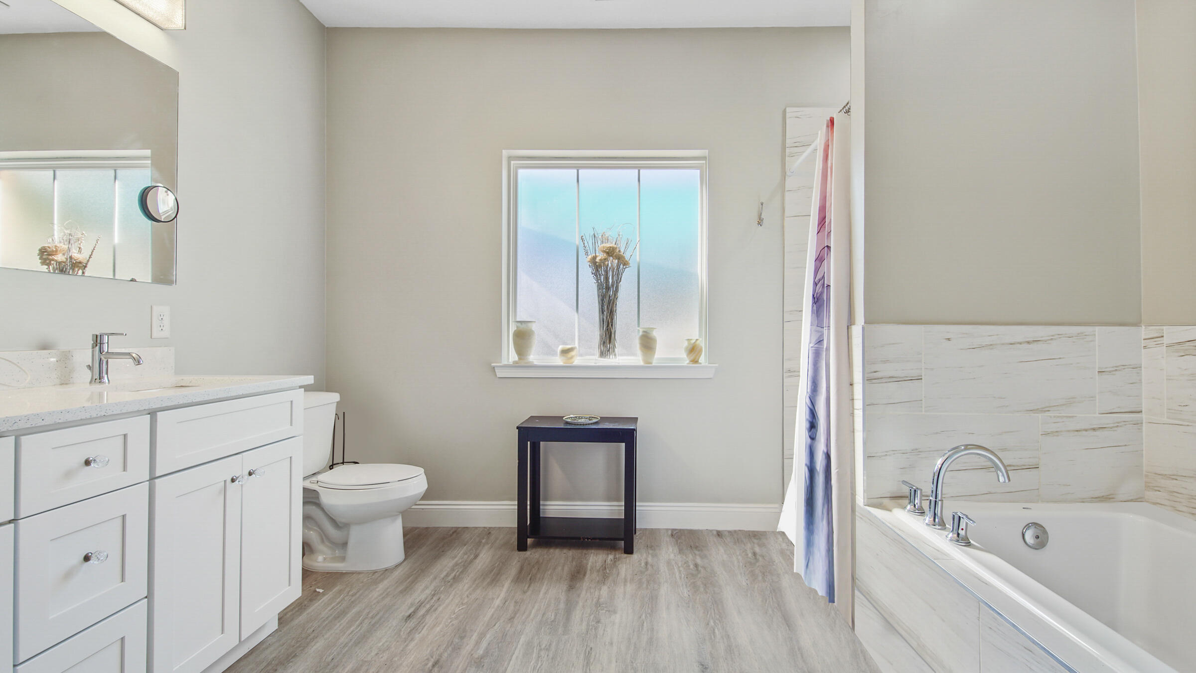 275 Indian Woman Road Santa Rosa Beach, FL 32459 - Photo 10 of 43 a bathroom with a sink a mirror and a bathtub