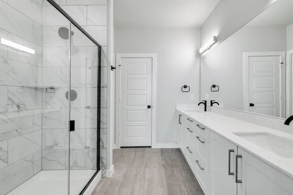 a spacious bathroom with a double vanity sink and mirror